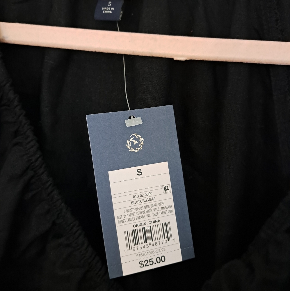 Women's Black long sleeved top with cinched waist and tie detail. Size small.